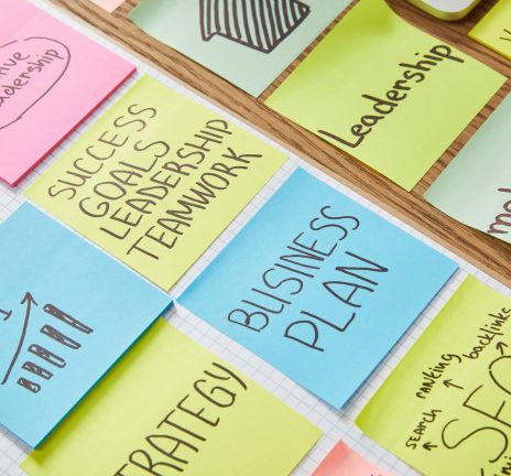 paper stickers with words teamwork, business plan and seo on tabletop